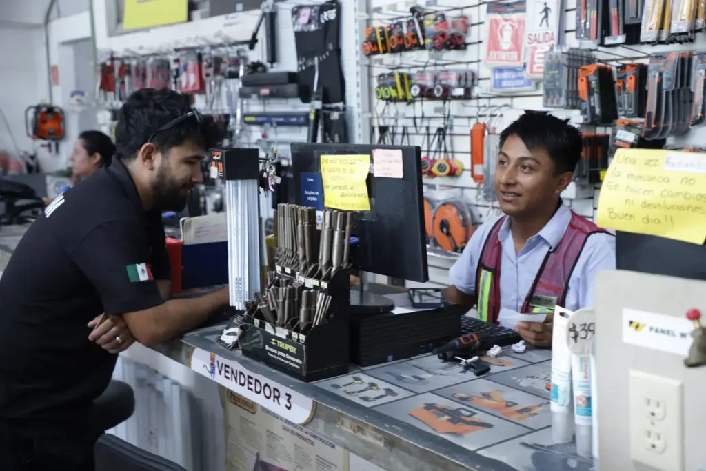 Cliente cotizando con un vendedor en el mostrador de la tienda